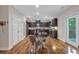 Eat-in kitchen boasts sleek dark cabinets, hardwood flooring, and modern appliances at 544 Pine Way, Dallas, GA 30157