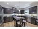Charming kitchen with stainless steel appliances, kitchen island, tile backsplash, and dark cabinets at 544 Pine Way, Dallas, GA 30157