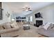 Bright living room with fireplace, hardwood floors, and open concept view to kitchen and dining area at 544 Pine Way, Dallas, GA 30157