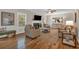 Inviting living room featuring a fireplace, hardwood flooring, and large windows at 544 Pine Way, Dallas, GA 30157