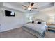 Calm primary bedroom featuring plush carpet, tray ceiling, ceiling fan, and lots of closet space at 544 Pine Way, Dallas, GA 30157