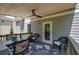 Covered deck with ceiling fan and outdoor dining area at 544 Pine Way, Dallas, GA 30157