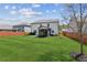 Expansive green backyard featuring a well-maintained lawn and a charming screened-in porch for outdoor enjoyment at 6435 Privet Way, Cumming, GA 30028