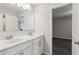 Dual sink bathroom vanity with white cabinets, framed mirror, and chrome fixtures at 6435 Privet Way, Cumming, GA 30028