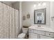Well-lit bathroom with vanity, toilet and shower at 6435 Privet Way, Cumming, GA 30028