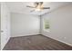 This comfortable bedroom has a ceiling fan, bright window and neutral walls with carpet at 6435 Privet Way, Cumming, GA 30028