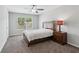 Cozy bedroom featuring a bed, nightstand with lamp, and natural light at 6435 Privet Way, Cumming, GA 30028