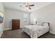 Comfortable bedroom with ceiling fan, window, and neutral decor at 6435 Privet Way, Cumming, GA 30028