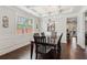 Formal dining room featuring a coffered ceiling, hardwood floors, and elegant lighting for sophisticated dining at 6435 Privet Way, Cumming, GA 30028