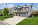 Spacious driveway leading to a charming two-story home with a two-car garage and lovely landscaping at 6435 Privet Way, Cumming, GA 30028
