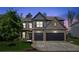 Beautiful two-story home with a well-manicured lawn, two-car garage and a brick facade at 6435 Privet Way, Cumming, GA 30028