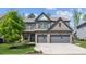 Beautiful two-story home with a well-manicured lawn, two-car garage and a brick facade at 6435 Privet Way, Cumming, GA 30028