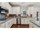 Gourmet kitchen with stainless steel appliances and granite countertops at 6435 Privet Way, Cumming, GA 30028