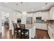Well-lit kitchen featuring stainless steel appliances, granite countertops, and hardwood floors at 6435 Privet Way, Cumming, GA 30028