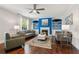 Cozy living room with fireplace, bright blue bookshelves and hardwood floors at 6435 Privet Way, Cumming, GA 30028