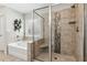 The bright bathroom boasts tiled shower with bench, soaking tub, and a decorative plant wall at 6435 Privet Way, Cumming, GA 30028
