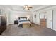 Expansive main bedroom featuring tray ceiling, carpet, french doors to bonus room, and plenty of space at 6435 Privet Way, Cumming, GA 30028
