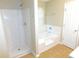 Bathroom featuring a shower, a tub, and tile flooring at 6991 Bonnes Blvd, Austell, GA 30168