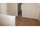 Spacious bedroom features neutral walls, plush carpet, and a doorway to another room at 6991 Bonnes Blvd, Austell, GA 30168