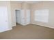 Bright bedroom features neutral walls, plush carpet, and window for natural light at 6991 Bonnes Blvd, Austell, GA 30168