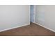 Bright bedroom featuring a window with blinds, a door, and neutral carpeting at 6991 Bonnes Blvd, Austell, GA 30168