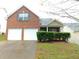 Charming brick home featuring a two-car garage and manicured front lawn at 6991 Bonnes Blvd, Austell, GA 30168