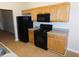 Efficient kitchen with black appliances, modern gas range, and light wood cabinets at 6991 Bonnes Blvd, Austell, GA 30168