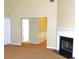A carpeted living room with a black fireplace and white fireplace mantle at 6991 Bonnes Blvd, Austell, GA 30168