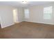 Spacious room with neutral walls, carpeting, and bright natural light from two windows at 6991 Bonnes Blvd, Austell, GA 30168