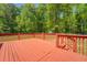 A well-maintained back deck featuring wooden railings and steps to the back yard at 70 Graystone Dr, Covington, GA 30014