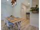 Bright dining room features stylish light fixture and farmhouse dining table at 70 Graystone Dr, Covington, GA 30014