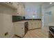 A well-designed modern kitchen with white cabinets, stainless appliances, and a herringbone backsplash at 70 Graystone Dr, Covington, GA 30014