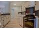 Charming kitchen features white cabinets, stainless steel appliances, and updated countertops at 70 Graystone Dr, Covington, GA 30014