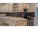 A well-designed kitchen with white cabinets, stainless appliances, and a herringbone backsplash at 70 Graystone Dr, Covington, GA 30014