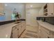 This charming kitchenette features white cabinets, stunning countertops, and modern hardware at 70 Graystone Dr, Covington, GA 30014