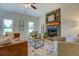 Comfortable living room with hardwood floors, a stone fireplace, and plenty of natural light at 70 Graystone Dr, Covington, GA 30014