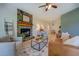 Bright living room featuring a stone fireplace, an area rug, and hardwood floors at 70 Graystone Dr, Covington, GA 30014