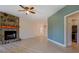 The open concept living room features a stone fireplace and contemporary lighting at 70 Graystone Dr, Covington, GA 30014