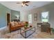 Cozy living room featuring modern decor and light coming in from two large bright windows at 70 Graystone Dr, Covington, GA 30014