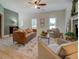 Relaxing living room with hardwood floors, two windows, and a decorative stone fireplace at 70 Graystone Dr, Covington, GA 30014