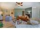 Cozy living room with hardwood floors, a ceiling fan, and a large couch with modern decor at 70 Graystone Dr, Covington, GA 30014