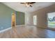 This large living room features two windows, a stylish paint color, and modern flooring at 70 Graystone Dr, Covington, GA 30014