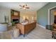 Inviting living room with a stone fireplace, ceiling fan, and stylish modern furniture at 70 Graystone Dr, Covington, GA 30014