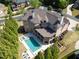 Overhead shot of the expansive home with a private pool and lush backyard at 8710 Merion Dr, Duluth, GA 30097
