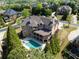 Aerial view of the large home with a private backyard pool and mature trees at 8710 Merion Dr, Duluth, GA 30097