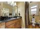Well-lit bathroom with a granite countertop, wood cabinetry, and elegant floral accents at 8710 Merion Dr, Duluth, GA 30097