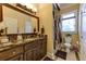 Bathroom with marble countertops, custom cabinets, and decorative fixtures at 8710 Merion Dr, Duluth, GA 30097