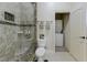 Bathroom with a glass shower, toilet, and doorway to a laundry area at 8710 Merion Dr, Duluth, GA 30097