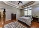 Bedroom with hardwood floors, dresser, ceiling fan, and natural light at 8710 Merion Dr, Duluth, GA 30097