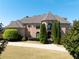Stunning brick home with turret, manicured lawn, and mature landscaping at 8710 Merion Dr, Duluth, GA 30097
